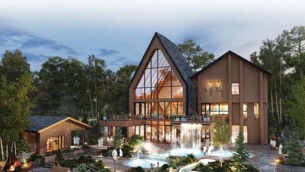 A modern lodge with a large glass facade, a waterfall feature, and a covered outdoor seating area.