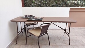 A small outdoor table with two chairs, a metal frame, and a cushion. - Casa Olmedina - Studio Apartment, Sleeps 2 (Olmedo)