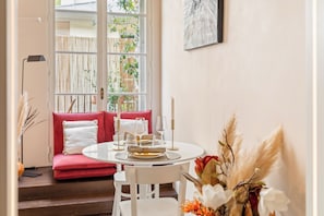 Enjoy meals for two in a stylish dining area with a round table, chair, and bench.