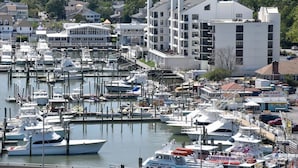 A marina with numerous boats docked, surrounded by buildings and greenery. - Beach House Oceanfront Condo | Indoor Pool Heated 606 (Virginia Beach)