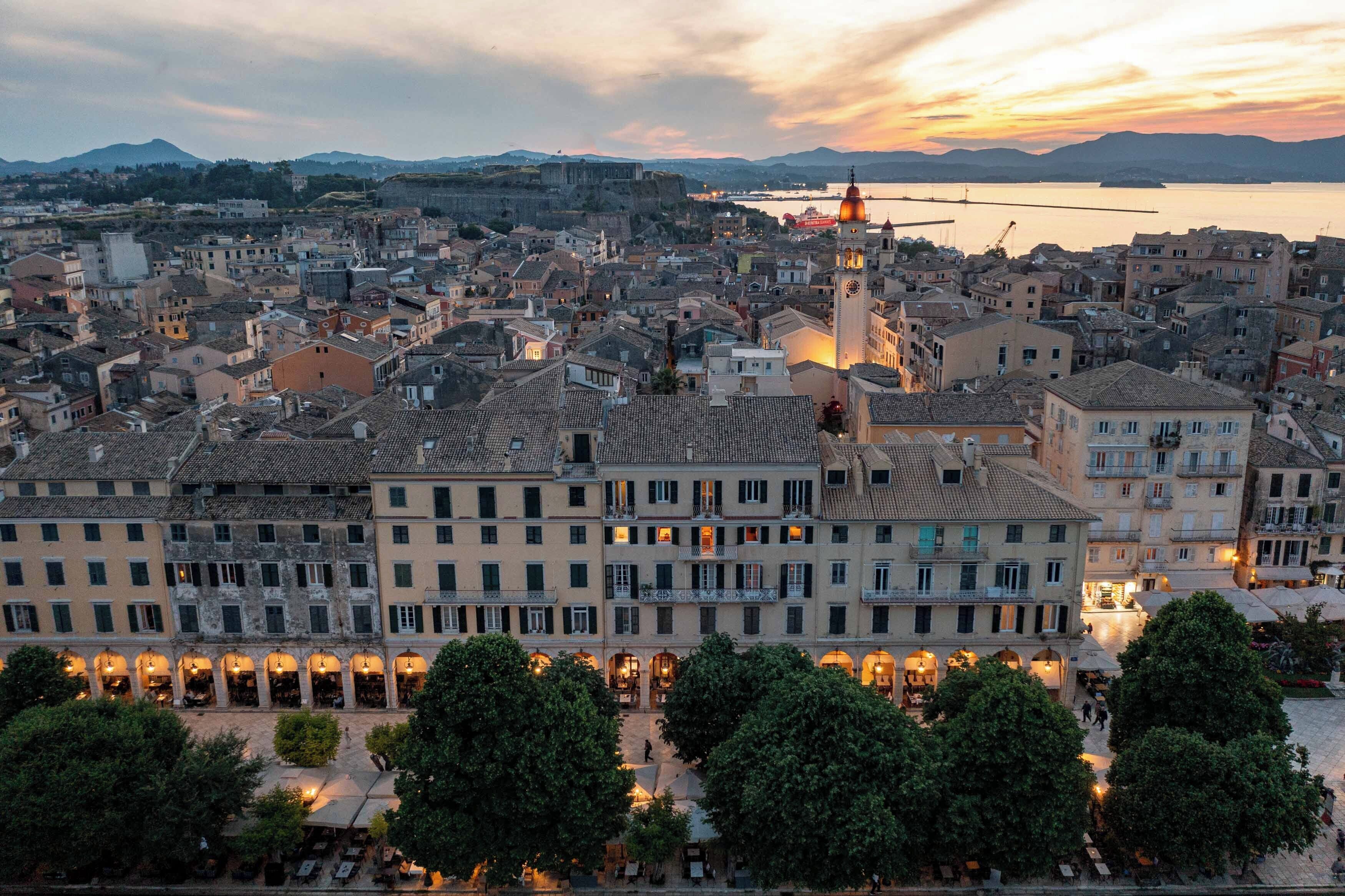 A historic town with a prominent tower, narrow streets, and a waterfront.