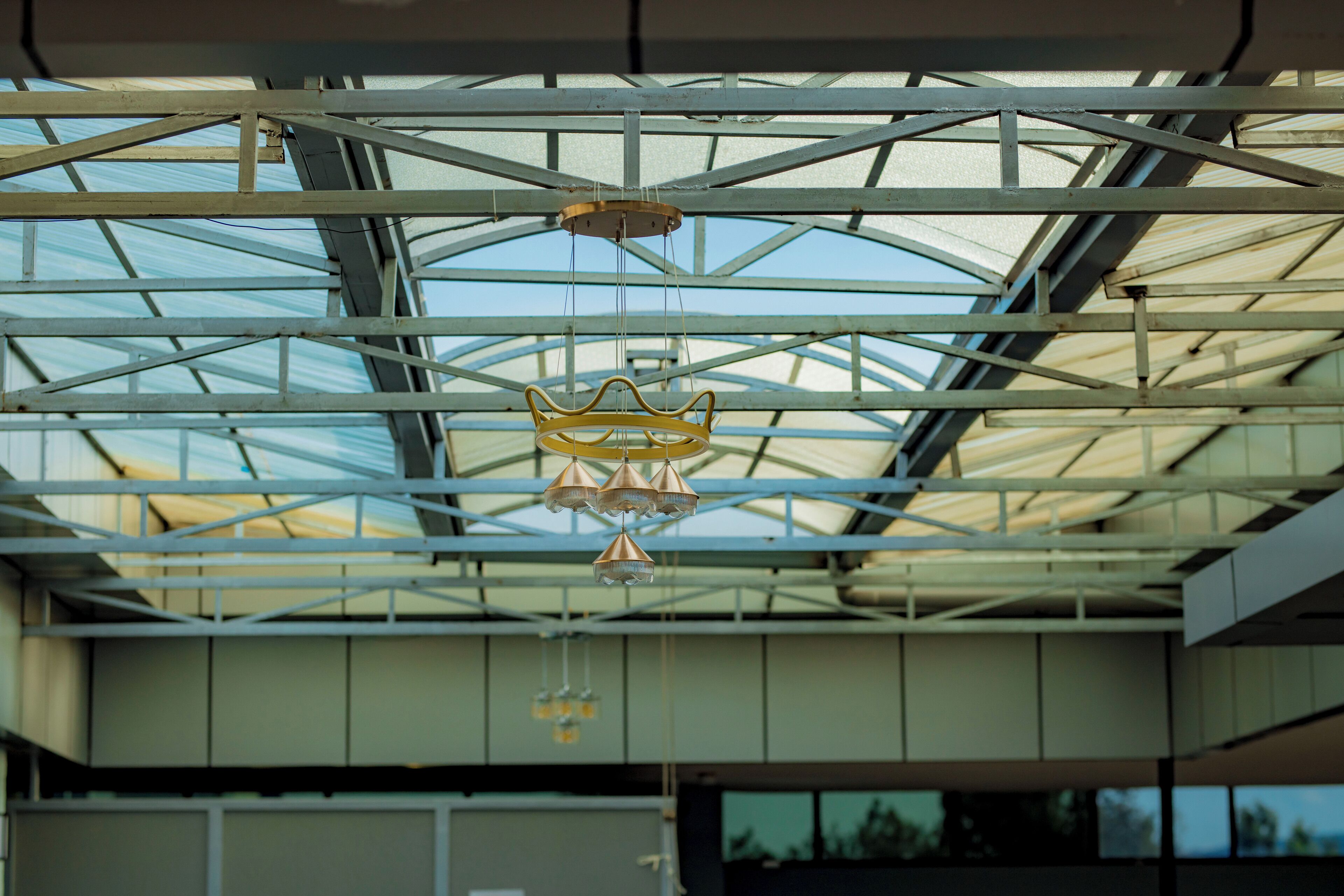 A modern building with a glass ceiling and metal framework.