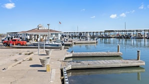 A marina with a dock, a red truck, and a building labeled "MARINA".