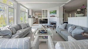 A spacious living room with a fireplace, two sofas, and a coffee table.