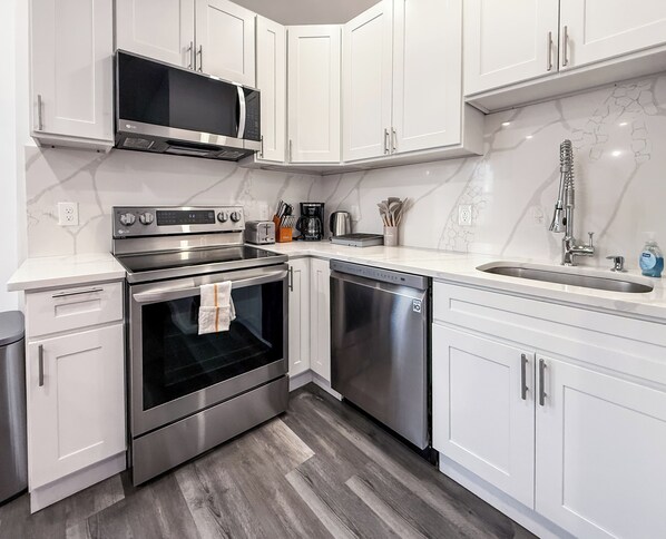 Enjoy meal preparation with a sink and stainless steel appliances.