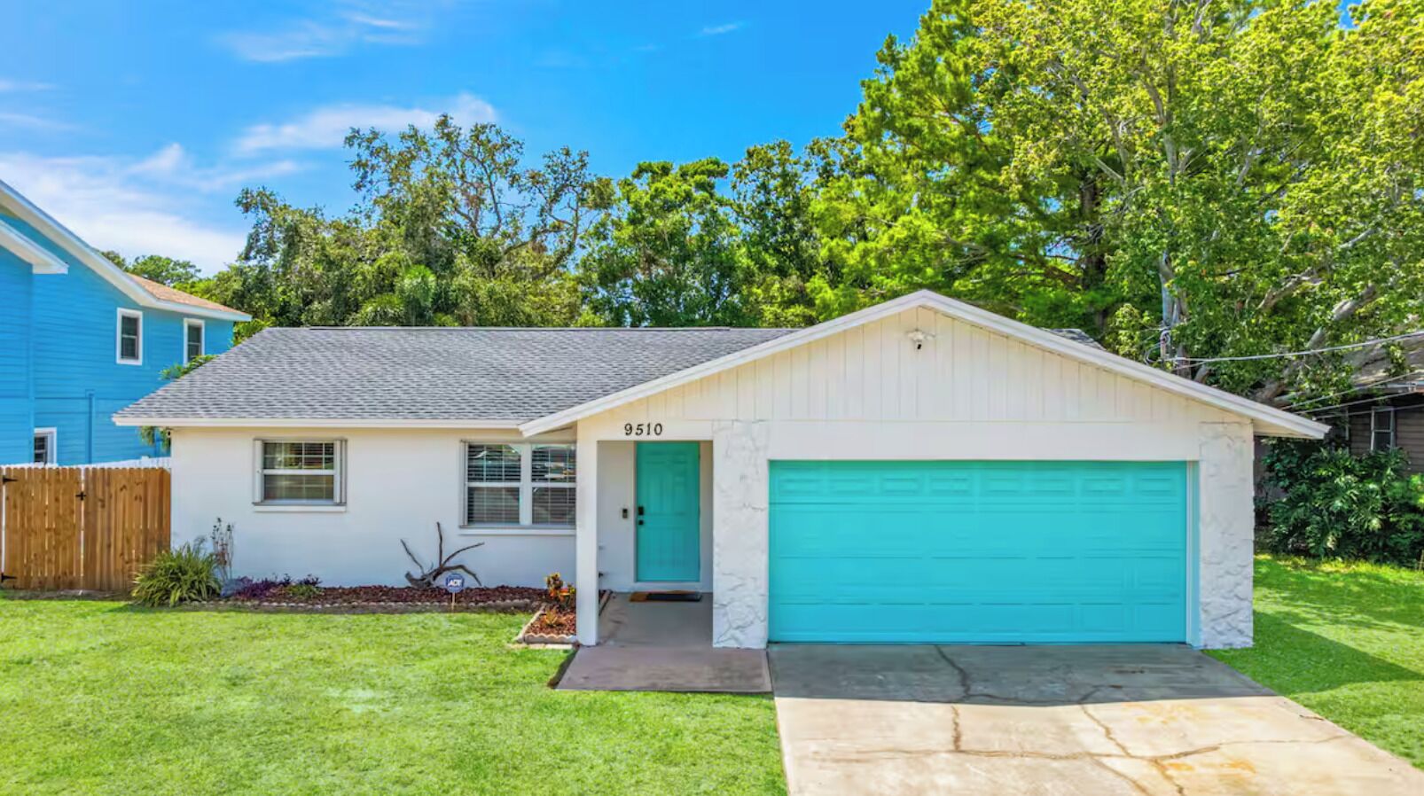 A single-story house with a garage, a front door, and a mailbox.