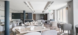 Enjoy dining in our stylish dining area with round tables and comfortable seating.