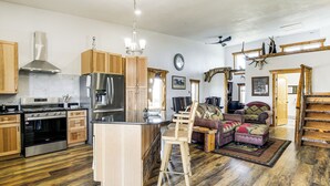 Una cocina amplia con armarios de madera, electrodomésticos de acero inoxidable y una isla central.