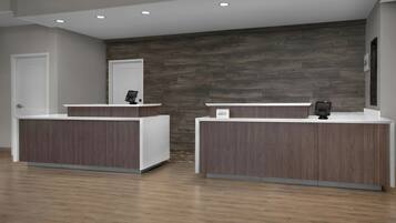 A reception area with two reception desks, a wooden wall, and a door.