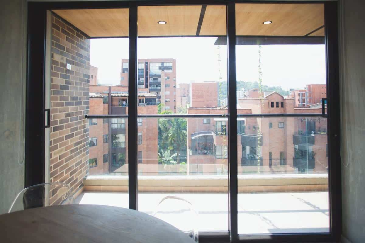 A room with a large window overlooking a cityscape.