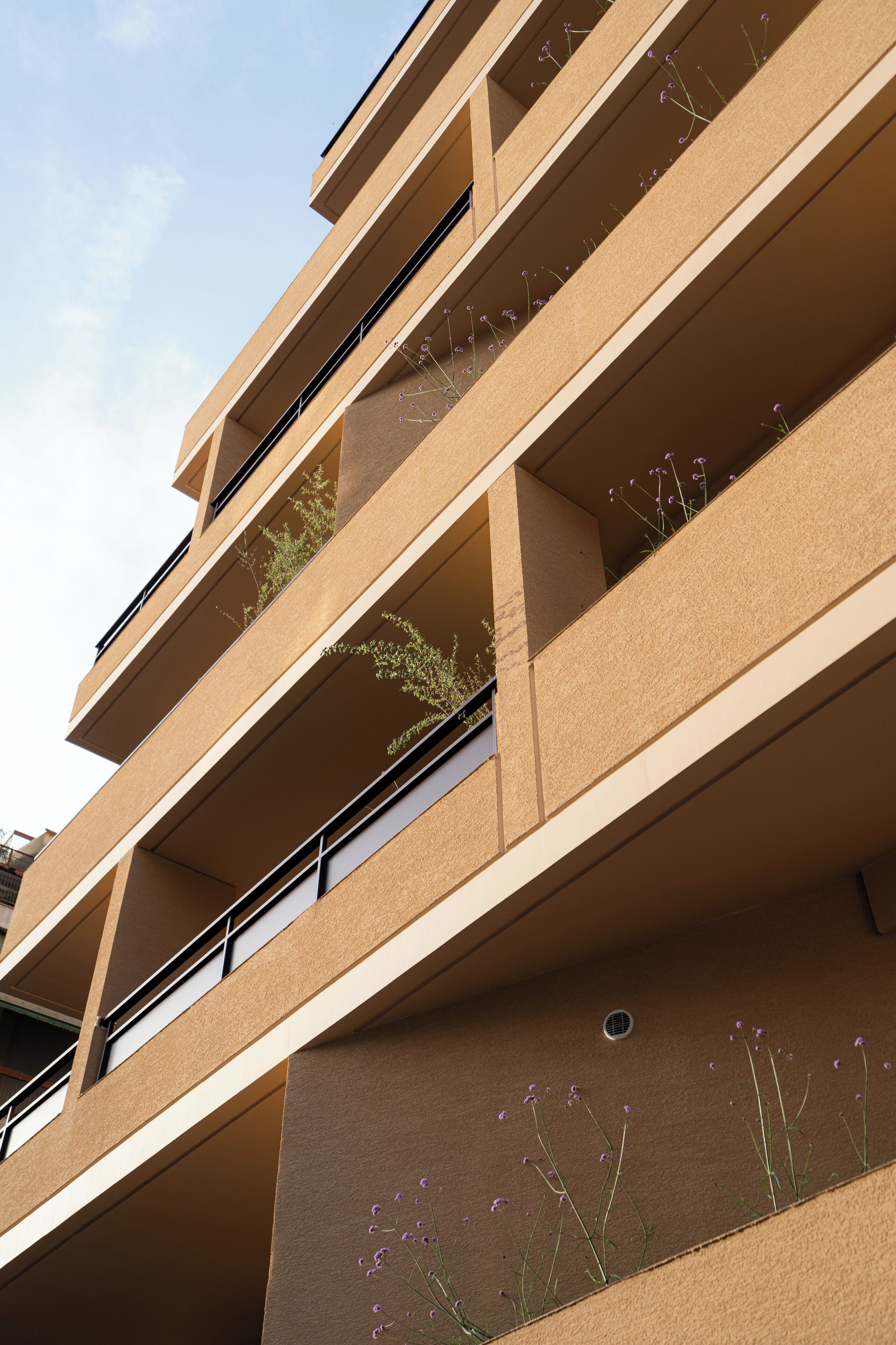 A multi-story building with balconies and windows.