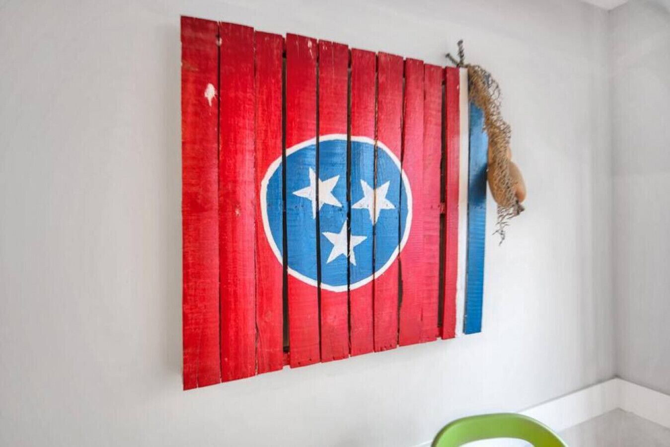 A wall with a red and blue painted wooden panel featuring a star emblem.