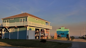 A two-story house with a balcony, a garage, and a porch area.
