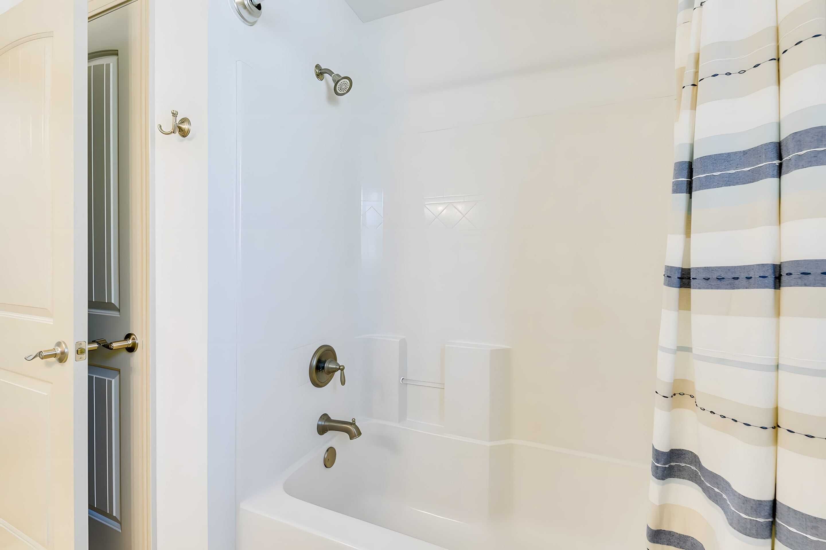 A bathroom with a bathtub, a shower, and a toilet.