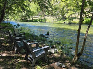 A riverside seating area with benches and a clear view of the water.