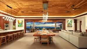 A spacious living area with a wooden ceiling, a dining table set for six, and a large sofa. - Kauai Oasis Luxe Ocean View, Pool SPA AC Sleep22 (Koloa)