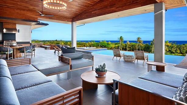 A modern outdoor lounge area with a pool, seating, and a view of the ocean. - Kauai Oasis Luxe Ocean View, Pool SPA AC Sleep22 (Koloa)