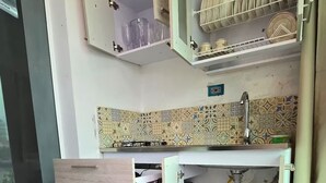 A compact kitchen with a built-in sink, upper cabinets, and a dish rack. - Loft Mr1-4g Facing the sea in a High Level Neighborhood (Cartagena)