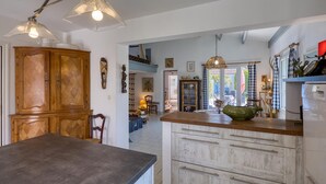 A kitchen with wooden cabinets, a large island, and pendant lighting. - 3 bedroom awesome home in Saint-Denis-d'Oléron (Saint-Denis-d'Oléron)