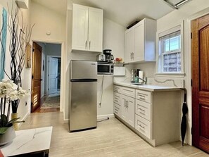 Fridge, microwave, stovetop, coffee/tea maker