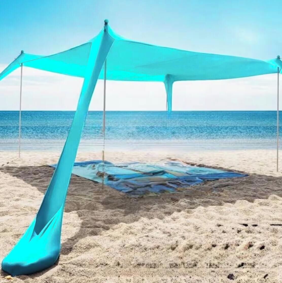 A beach with a large, translucent canopy structure.