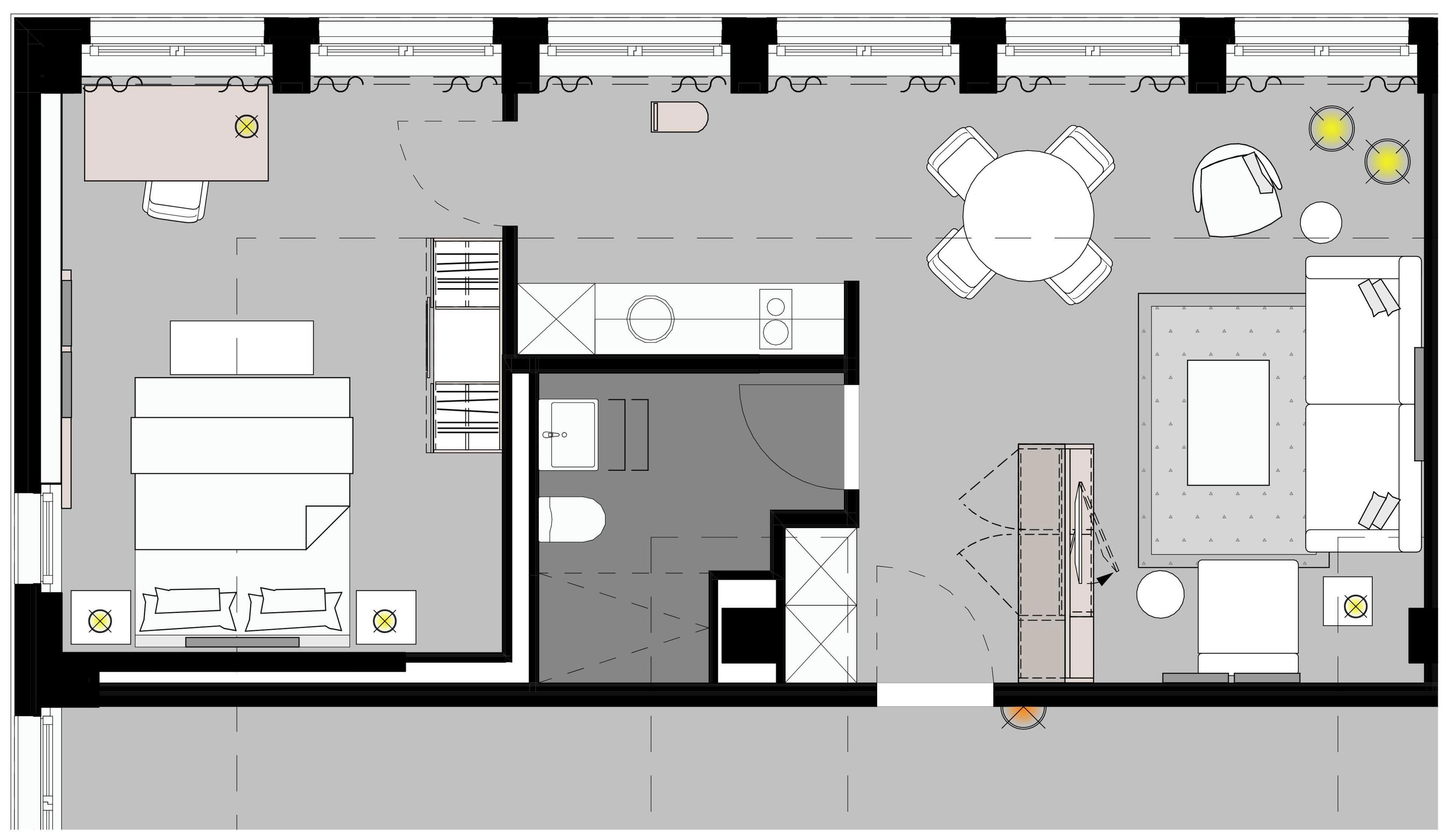 En planritning över ett hotellplan med ett centralt placerat matområde, flera sovrum, ett badrum och ett kök.