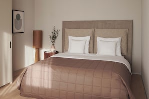 Relax in a serene space with a large bed, nightstand, and framed picture.