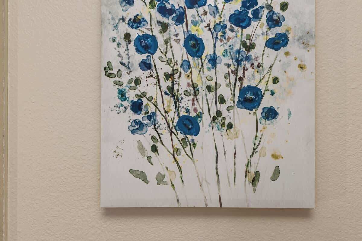 Ein Gemälde von blauen Blumen vor weißem Hintergrund.