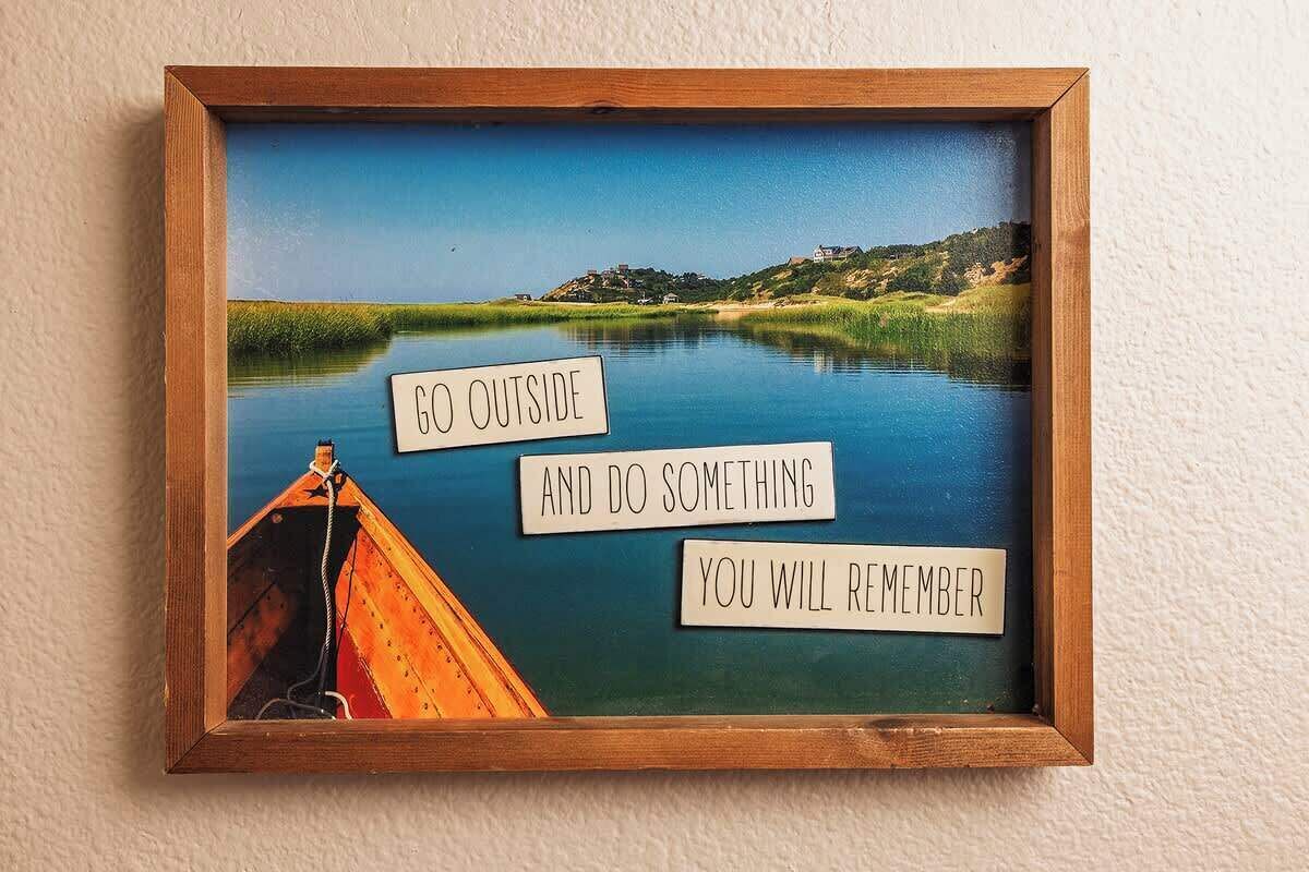 Un marco con una cita inspiradora y un barco en un río tranquilo.