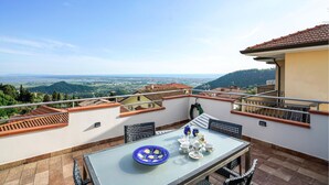 A terrace with a table set for tea, overlooking a scenic landscape. - Beautiful home in Corsanico (Corsanico)