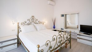 A neatly arranged bedroom with a bed, bedside tables, a dresser, a TV, and a mirror. - Beautiful home in Corsanico (Corsanico)