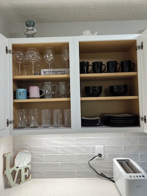 Kitchen cabinet with ample storage and wine glass storage.