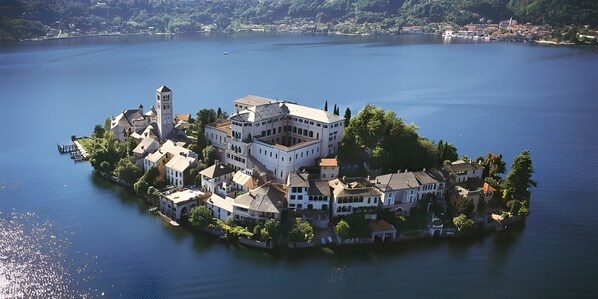 A lakeside property with a central building, a tower, and multiple surrounding structures.