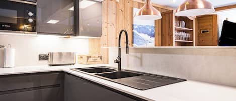 Een magnetron, een oven, een kookplaat, een vaatwasser