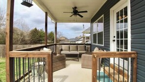 A covered porch with a ceiling fan, outdoor furniture, and a pool. - Beautiful, Cozy  and Airy Retreat with Lots of Character - NO CLEANING FEE (Clarksville)