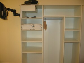 Ample storage space with a convenient closet featuring multiple shelves and a hook for your belongings.