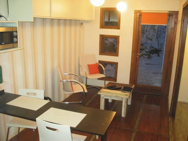 Cozy retreat with a kitchenette, dining table, and comfortable seating area.