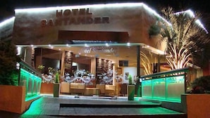 The exterior of Hotel Santander with a modern design, featuring a prominent entrance and decorative elements. - Hotel Santander (Villa Carlos Paz)