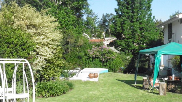 A backyard with a swimming pool, a swing set, and a tent. - Hosteria Suyana (San Salvador de Jujuy)