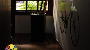 A room with a window, a bicycle mural, and a door.