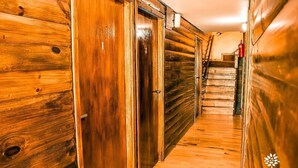 A wooden hallway with doors, a staircase, and a fire extinguisher. - Senador Dupont (Tigre)