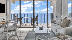 A balcony with a view of the sea, furnished with a table, chairs, and a sofa. - Seagull Heights! 2-BR 2-BA OCEANFRONT Royal Garden Resort Condo In&Outdoor Pools (Murrells Inlet)