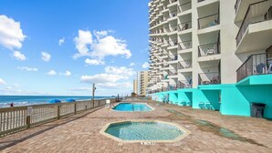 A beachfront pool area with a wooden deck, two pools, and a high-rise building with balconies. - Seagull Heights! 2-BR 2-BA OCEANFRONT Royal Garden Resort Condo In&Outdoor Pools (Murrells Inlet)