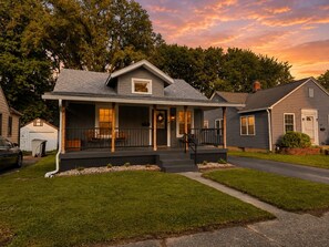 A single-story house with a front porch, a garage, and a well-maintained lawn.