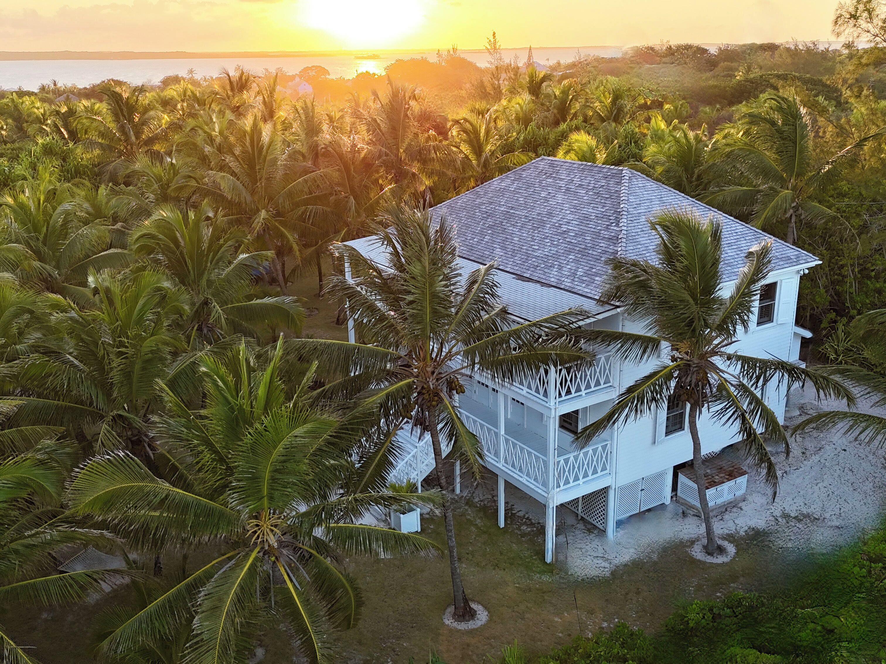 The Guest House at Hibiscus Hill seen from above as the sun dips into the bay