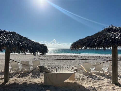 Theatrical retreat set just above Harbour Island's Pink Sand Beach, bold design meets island calm
