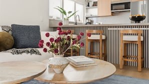 A modern kitchen with wooden cabinets, a built-in microwave, and a stainless steel refrigerator. - Tide House | Manhattan Beach - Unit B - Seaside w/ Parking (Manhattan Beach)