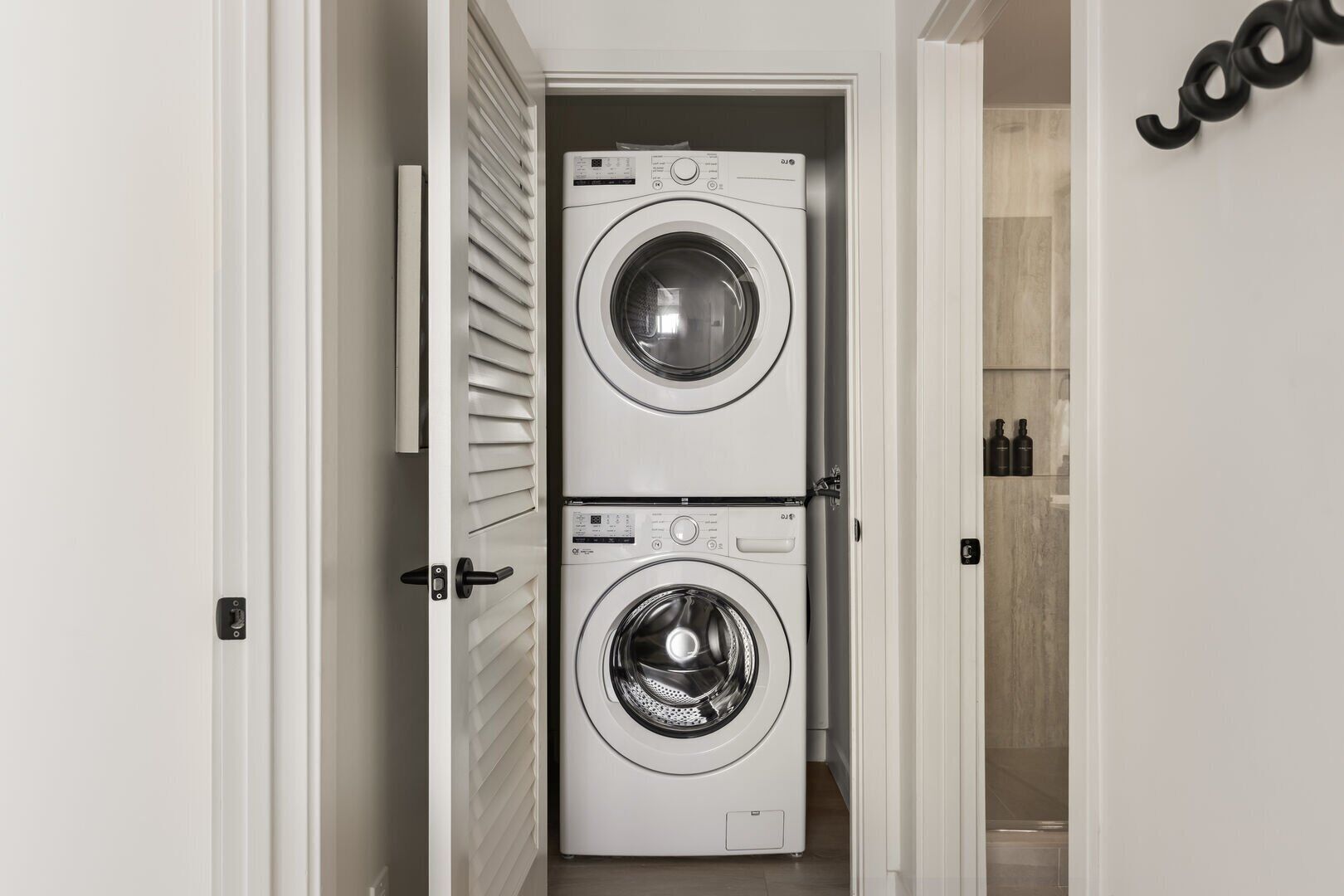 A laundry room with two stacked front-loading washing machines.