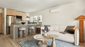 A modern apartment with a kitchen, dining area, and living room. - Tide House | Manhattan Beach - Unit C - Seaside w/ Parking (Manhattan Beach)