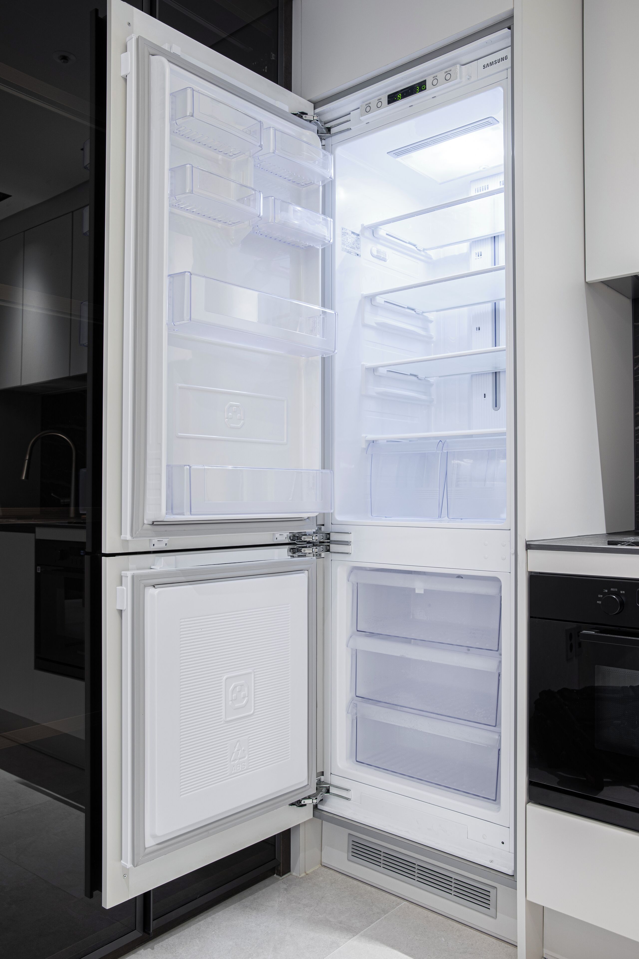 A modern kitchen with a built-in refrigerator, a microwave, and a stove.